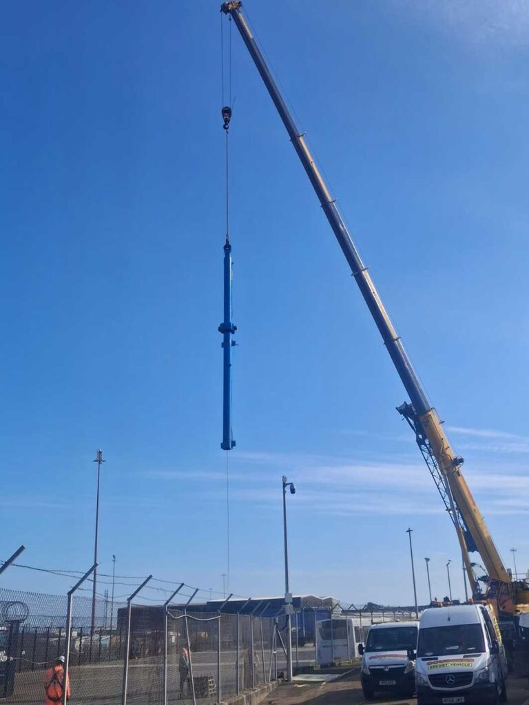 hydraulic ram suspended from crane