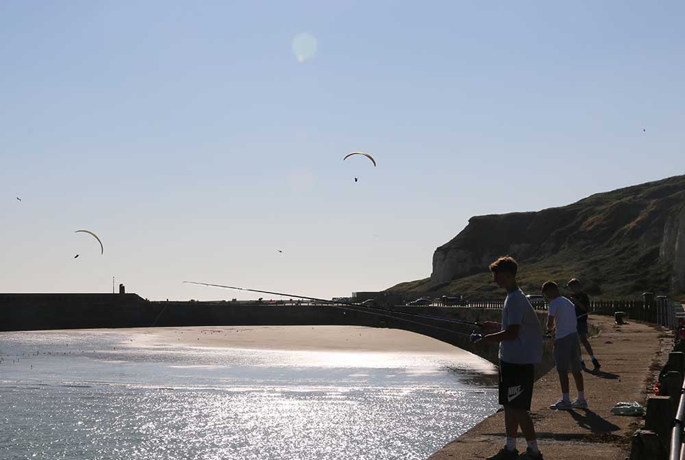 Boys fishing on coast