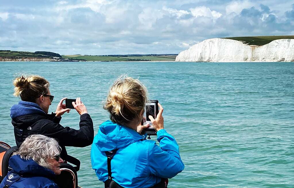 people taking photos of English cliffs