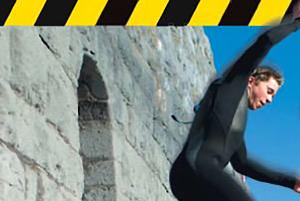 man jumping from cliff