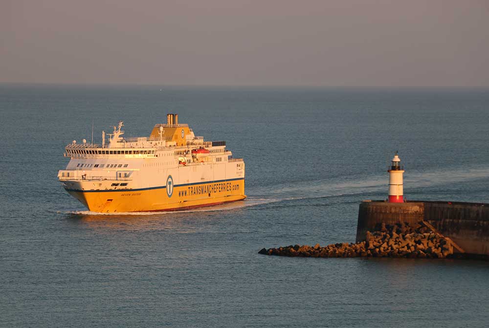 Ferry coming into Newhaven Port caught by sun late afternoon as it passes the lighthouse