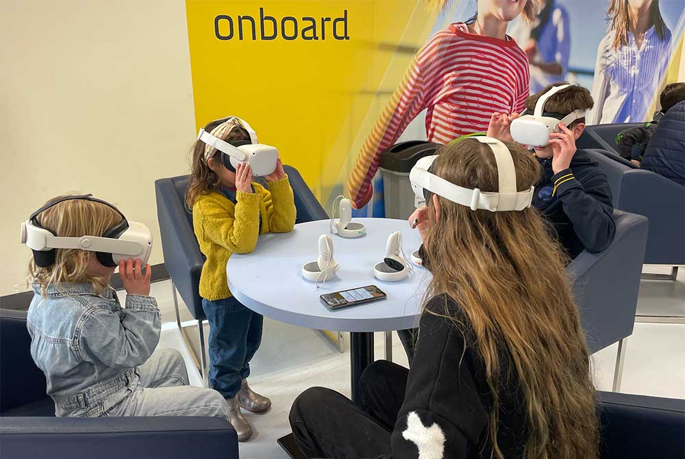 kids in headsets in Newhaven Port waiting room