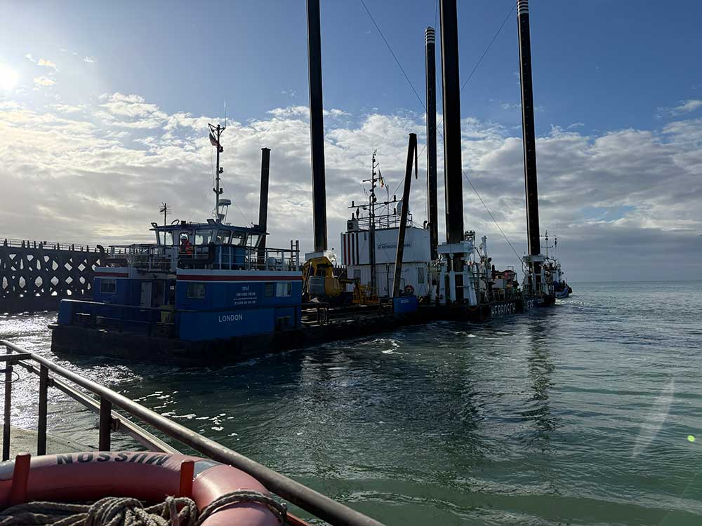 As the sun rises the Octopus platform is towed out of Newhaven Port